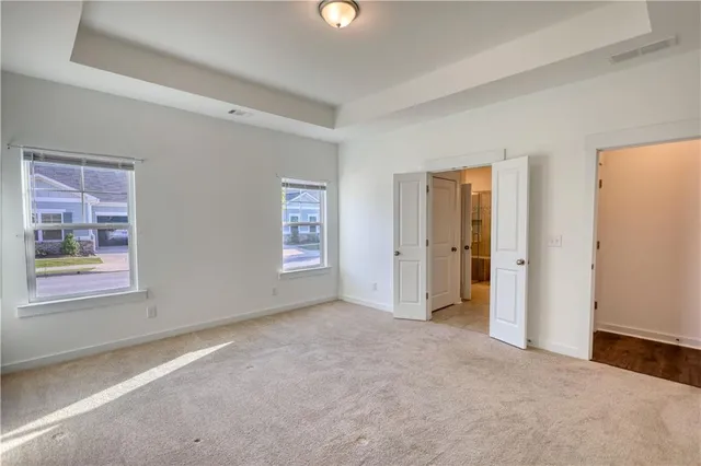 an empty room with windows and closet