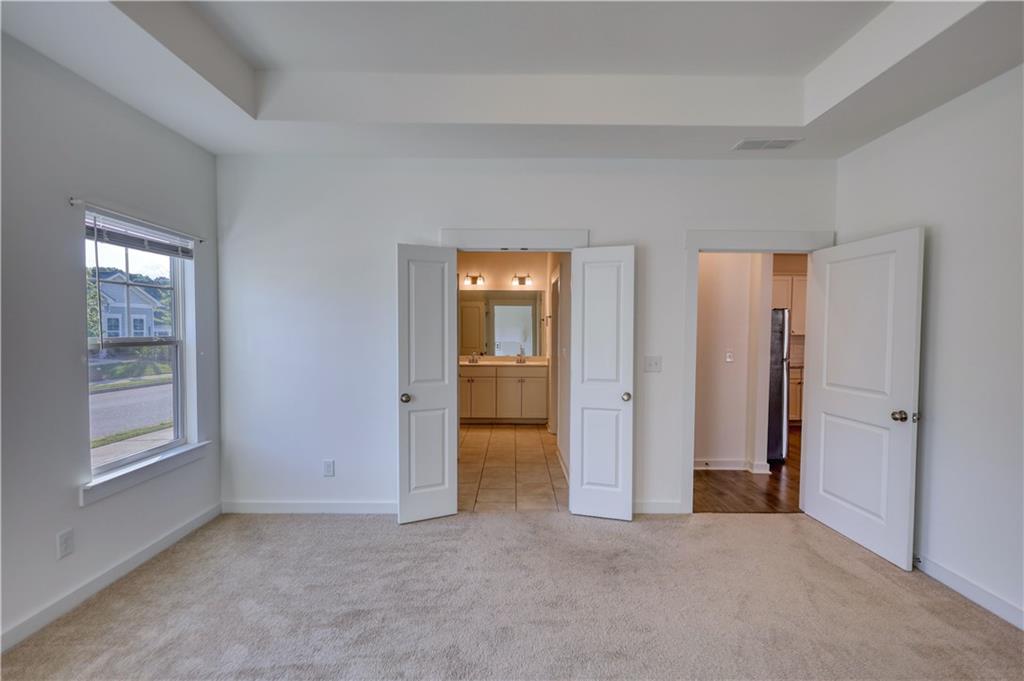 2929 Rambler Drive Loganville, GA 30052 - Photo 34 of 49 an empty room with windows and closet