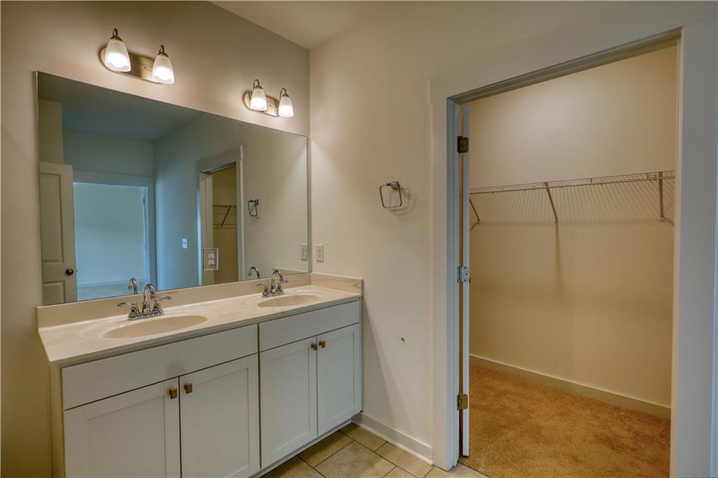2929 Rambler Drive Loganville, GA 30052 - Photo 39 of 49 a bathroom with a double vanity sink mirror and shower