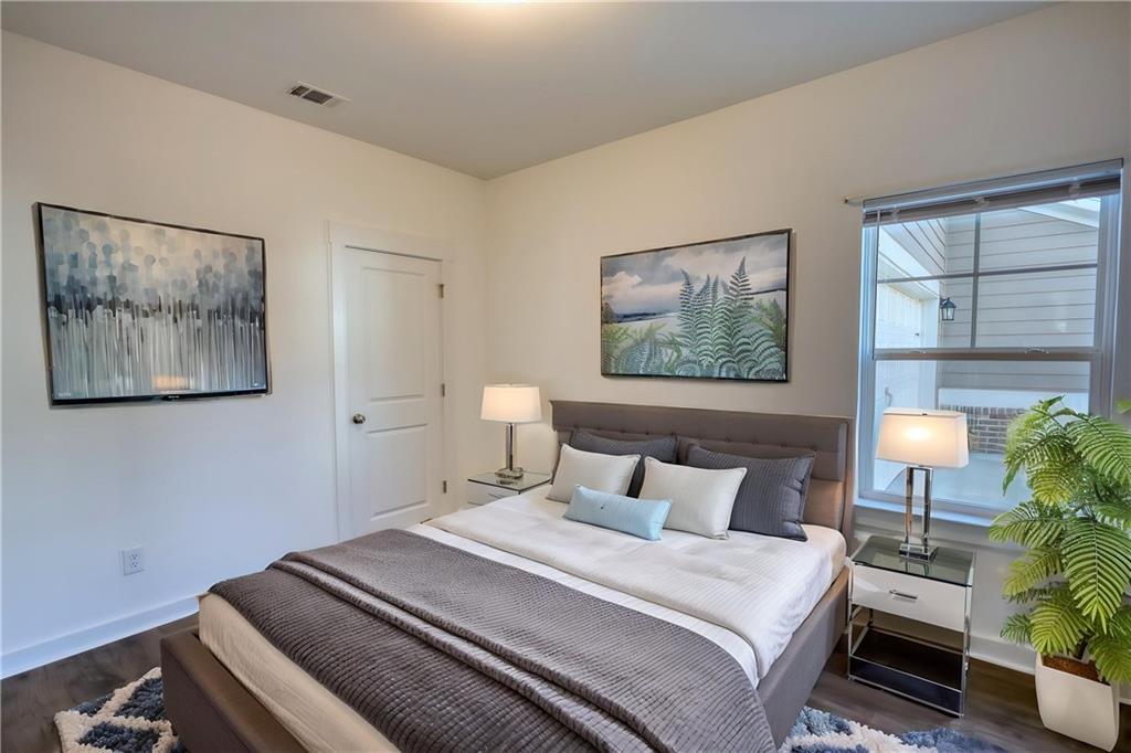 2929 Rambler Drive Loganville, GA 30052 - Photo 47 of 49 a bedroom with bed and a potted plant