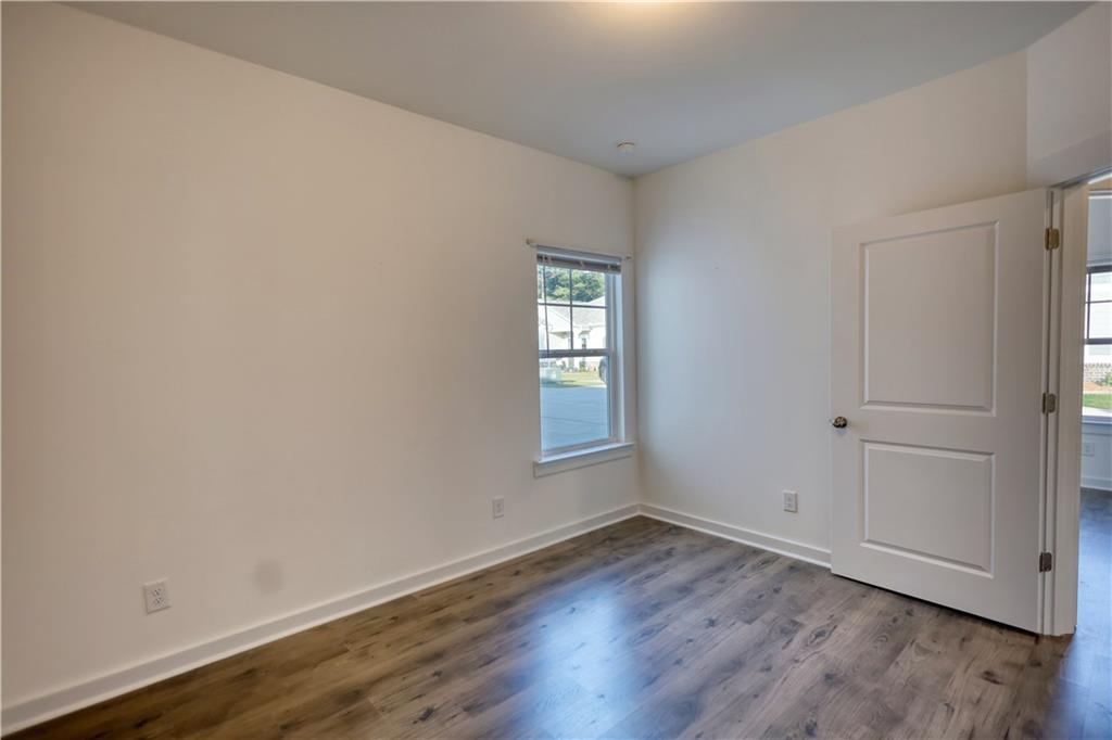 2929 Rambler Drive Loganville, GA 30052 - Photo 48 of 49 a view of an empty room with wooden floor and window