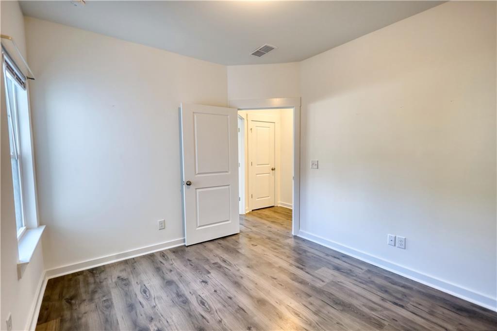 2929 Rambler Drive Loganville, GA 30052 - Photo 49 of 49 an empty room with wooden floor and closet