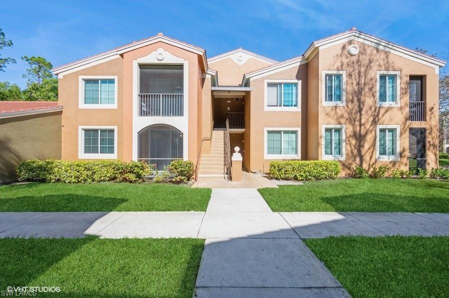1170 Reserve Way, Unit 107 Naples, FL 34105 - Photo 1 of 41 View of front facade featuring a front lawn