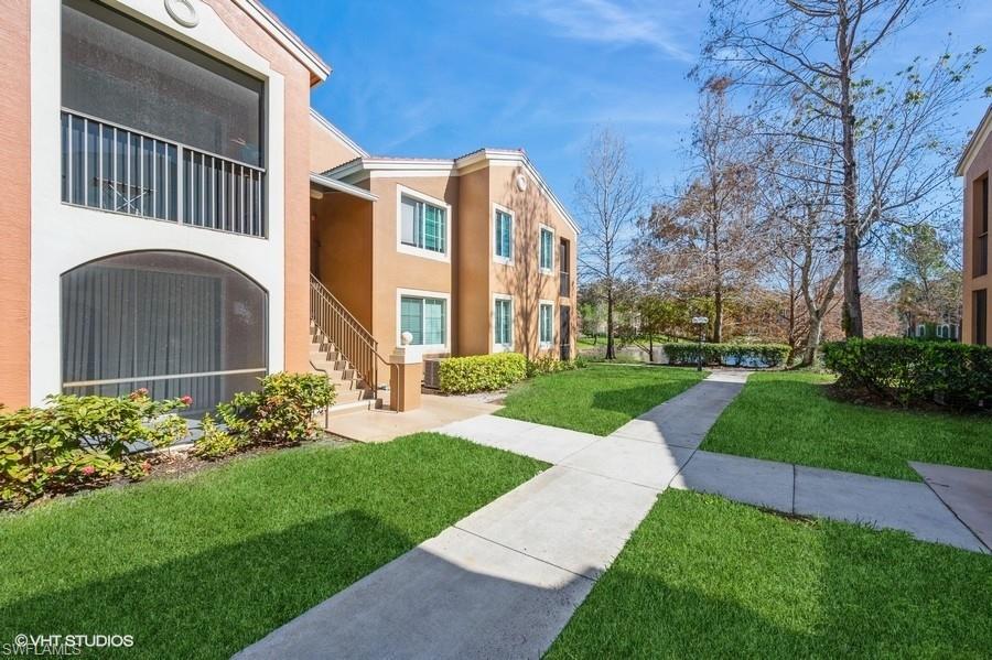 1170 Reserve Way, Unit 107 Naples, FL 34105 - Photo 2 of 41 View of community with a yard