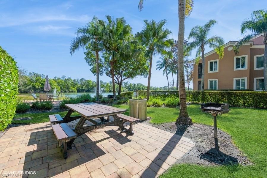 1170 Reserve Way, Unit 107 Naples, FL 34105 - Photo 32 of 41 Grill area with lake view by pool
