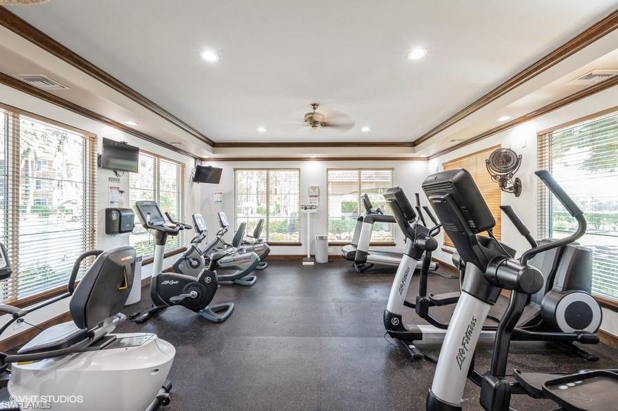 1170 Reserve Way, Unit 107 Naples, FL 34105 - Photo 38 of 41 Gym with crown molding and ceiling fan