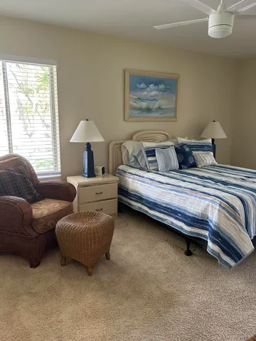 a bedroom with bed couch and window