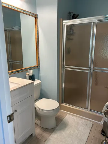 a bathroom with a toilet and a shower