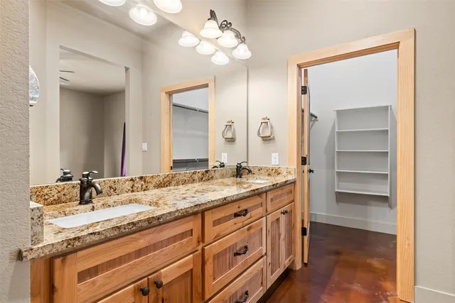 a bathroom with a sink double vanity and a mirror