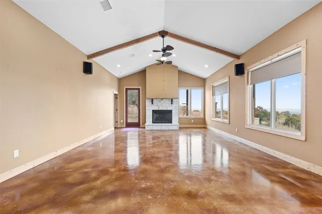 a view of kitchen with stainless steel appliances granite countertop a stove and cabinets