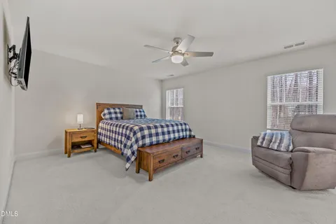 a bedroom with a bed and a television