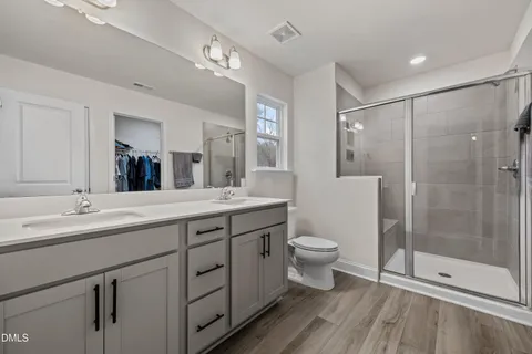 a view of walk in closet with clothes and shoes