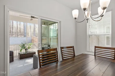 a kitchen with a sink a microwave a refrigerator and white cabinets