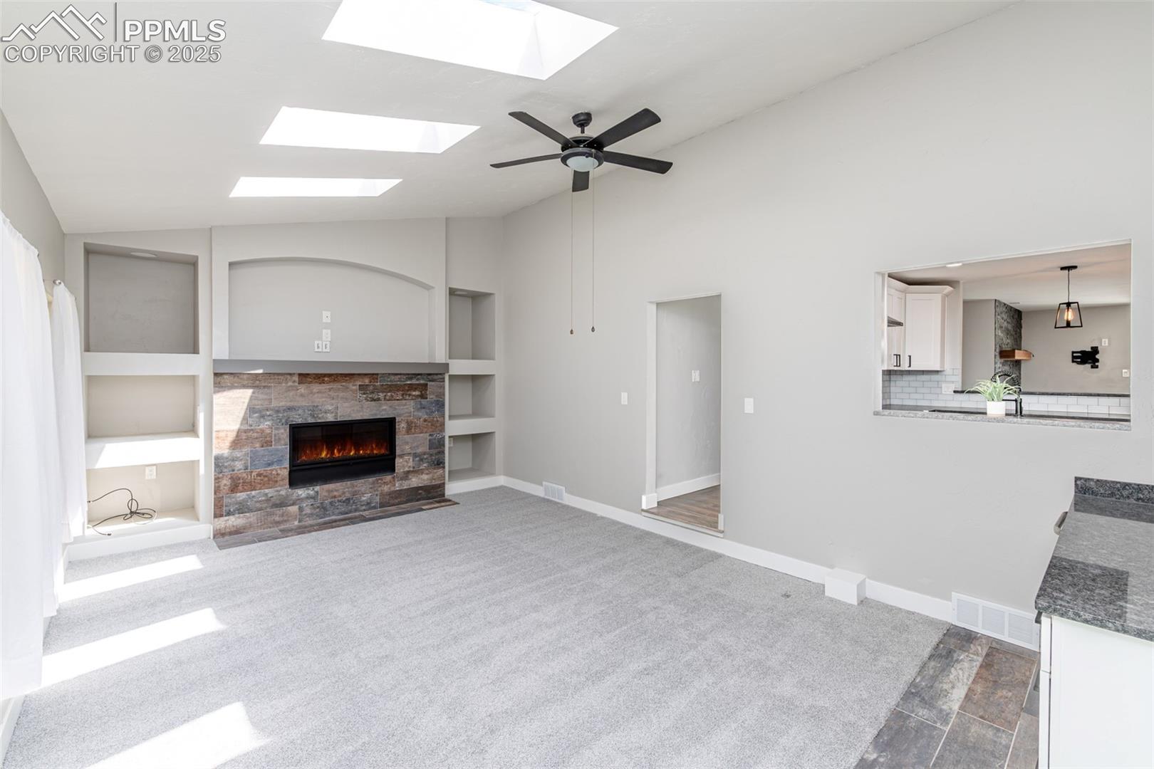 721 Forest View Road Monument, CO 80132 - Photo 31 of 47 Skylights, gas fireplace and a sliding door the backyard.
