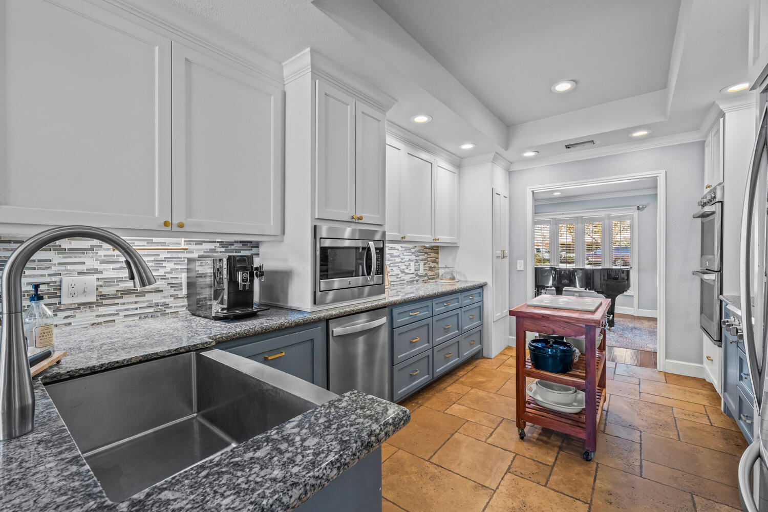 3114 76th Street Lubbock, TX 79423 - Photo 29 of 77 a kitchen with stainless steel appliances granite countertop a stove a sink and a microwave