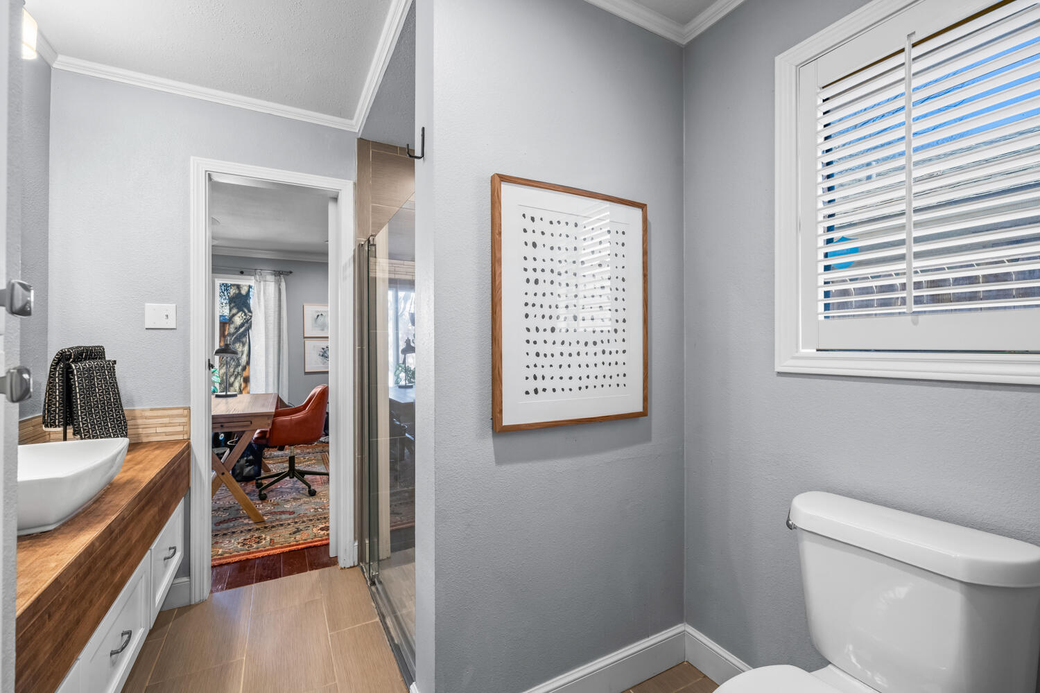 3114 76th Street Lubbock, TX 79423 - Photo 51 of 77 a bathroom with a toilet a sink and a window