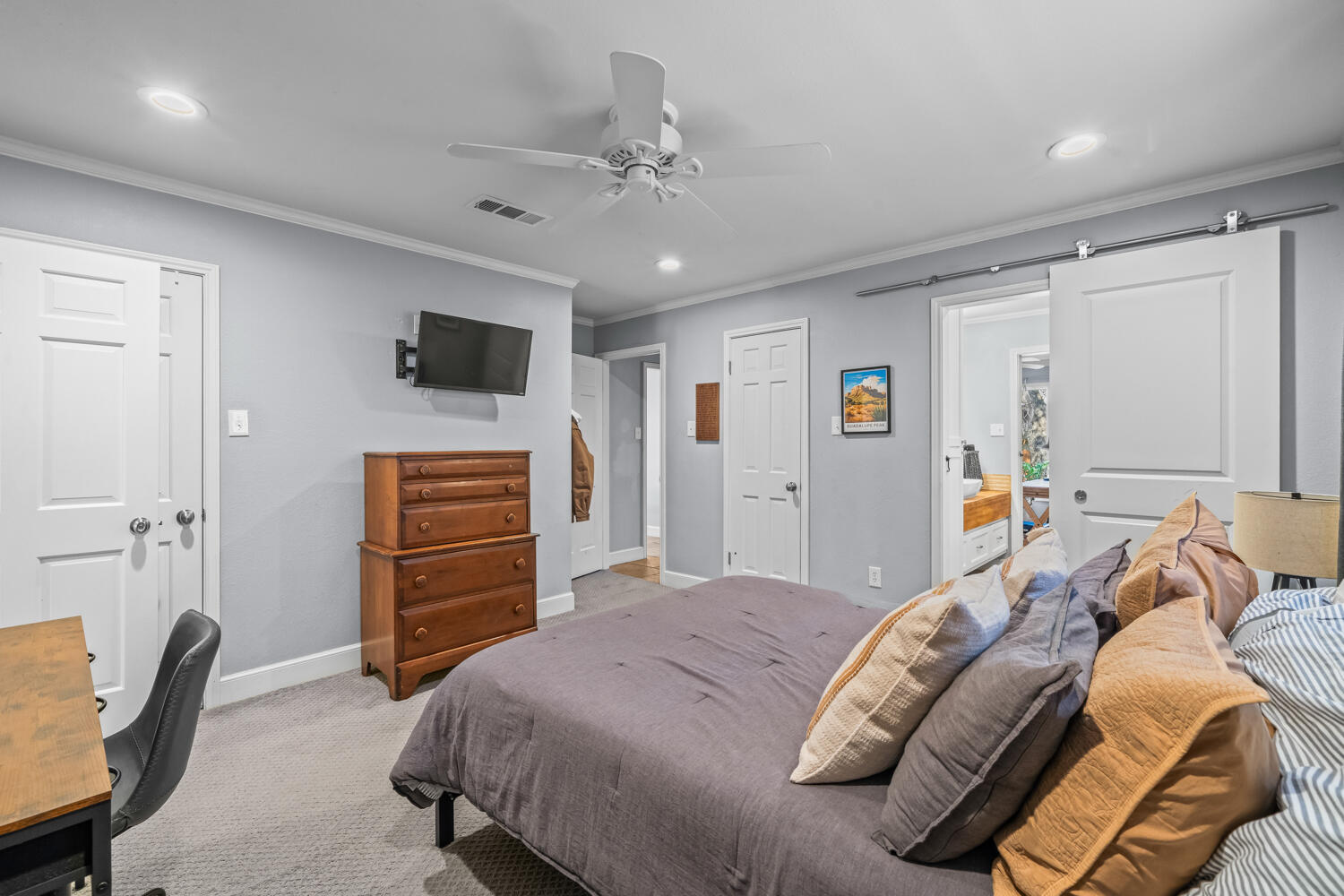 3114 76th Street Lubbock, TX 79423 - Photo 58 of 77 a bedroom with a bed and a television