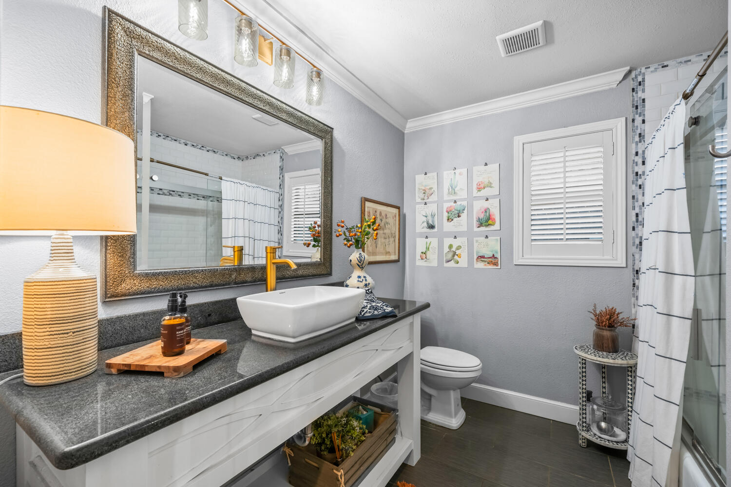 3114 76th Street Lubbock, TX 79423 - Photo 59 of 77 a bathroom with a sink a toilet and a mirror