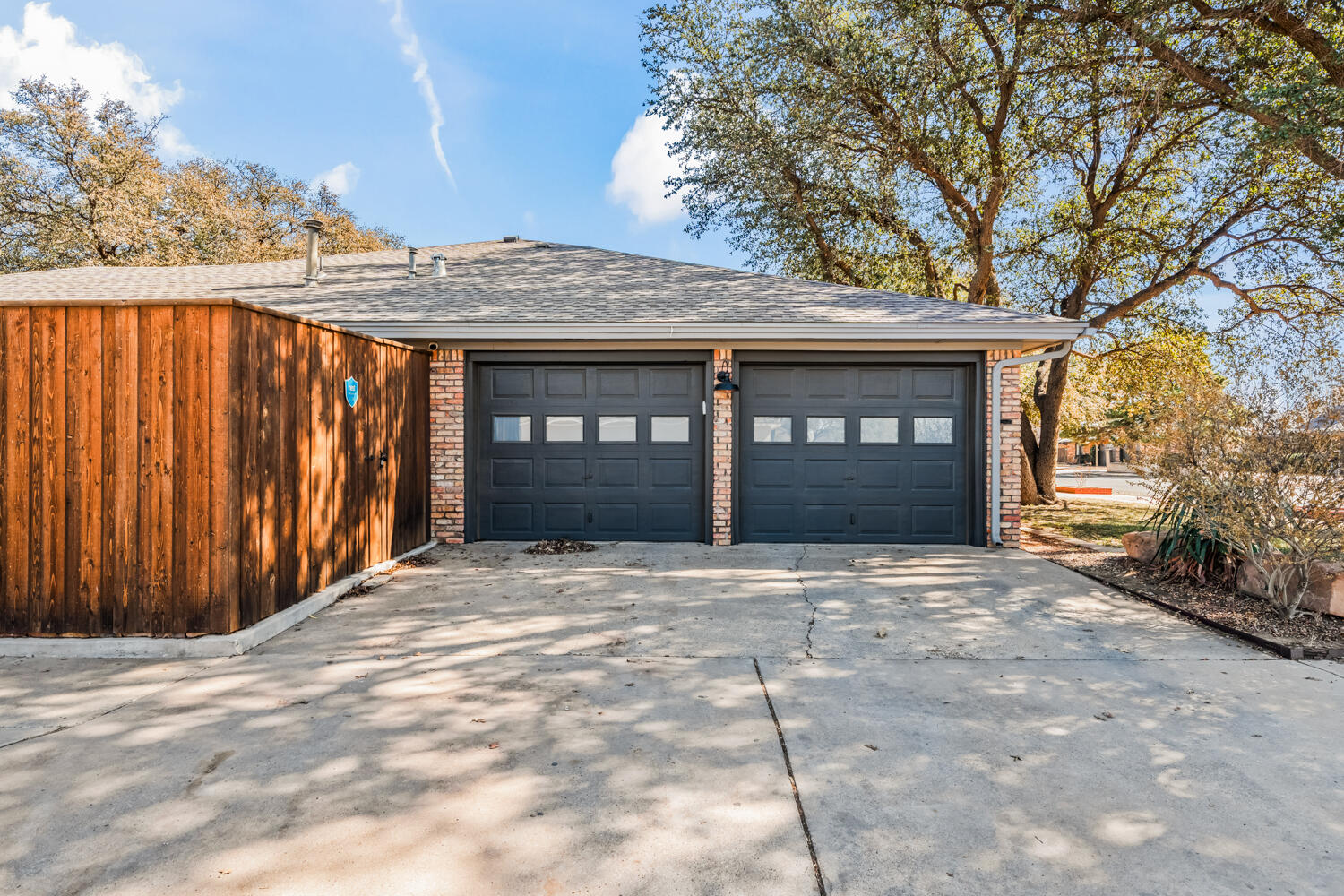 3114 76th Street Lubbock, TX 79423 - Photo 72 of 77 a front view of a house with a yard and garage