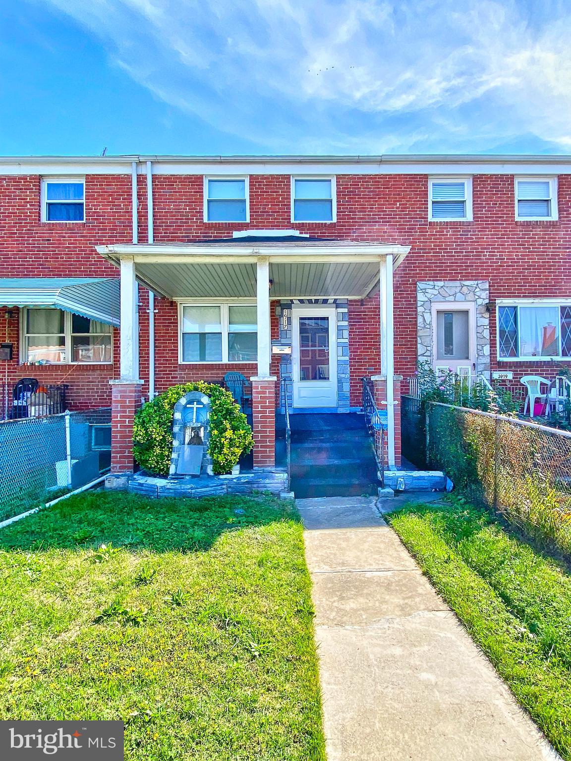 1917 Inverton Road Baltimore, MD 21222 - Photo 3 of 51 a front view of a brick house with a yard