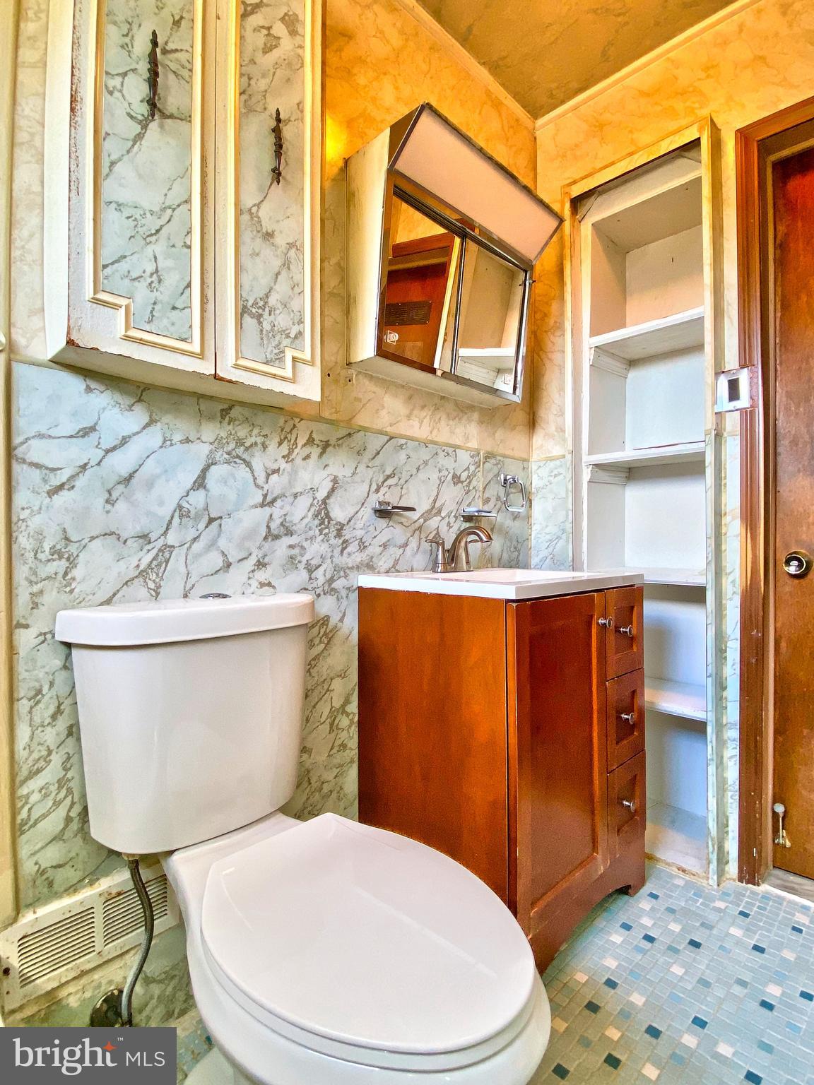 1917 Inverton Road Baltimore, MD 21222 - Photo 44 of 51 a white toilet sitting next to a bathroom sink