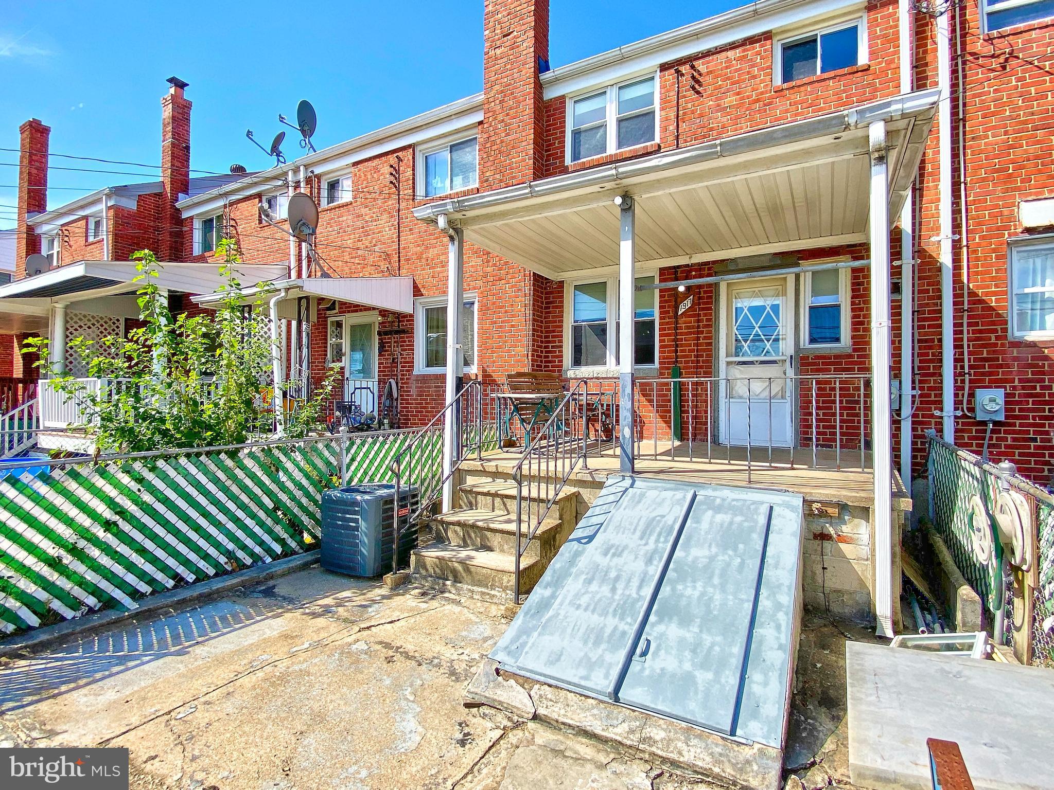 1917 Inverton Road Baltimore, MD 21222 - Photo 49 of 51 a view of a house with a chairs and table in a patio