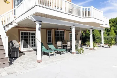 a building outdoor space with couple of furniture and outdoor seating