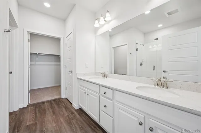 a spacious bathroom with a double vanity sink double and mirror