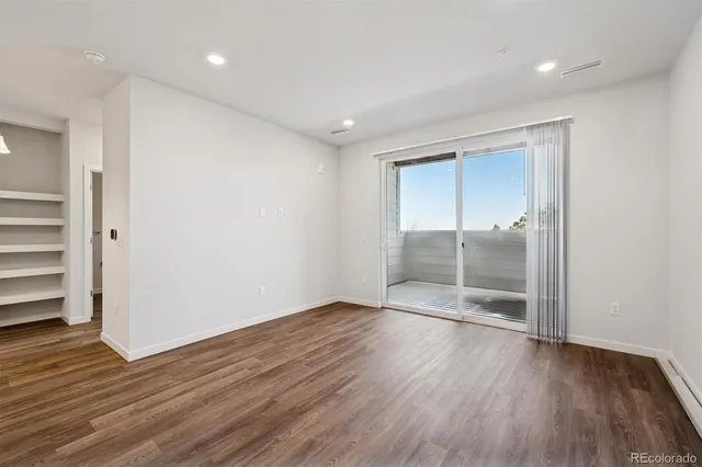 a view of wooden floor and windows in a room