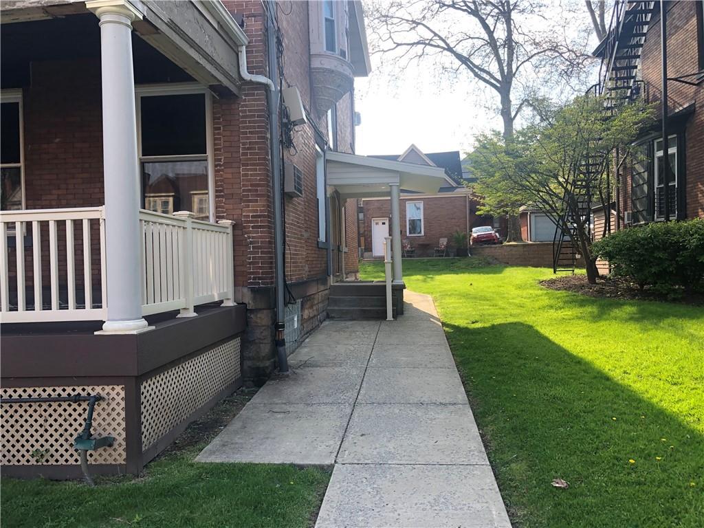 342 South Graham Street Pittsburgh, PA 15232 - Photo 3 of 9 a view of a house with a large window and a yard