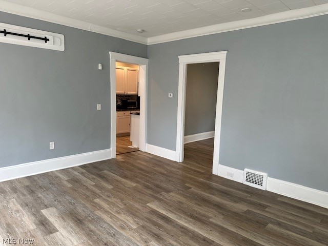 1388 Brookline Road Cleveland, OH 44121 - Photo 19 of 30 Empty room featuring dark hardwood / wood-style floors and crown molding