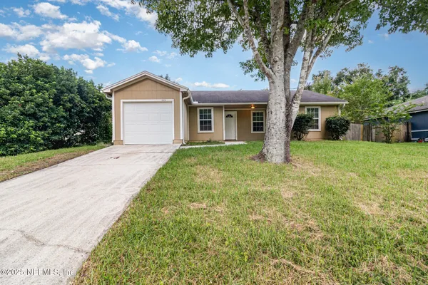 a front view of house with yard and green space