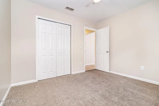 an empty room with closet area