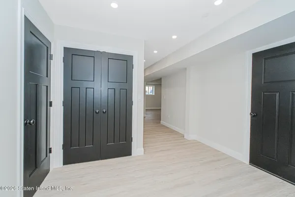 a view of hallway with wooden floor