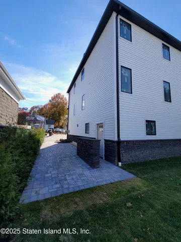 a view of backyard of house with green space