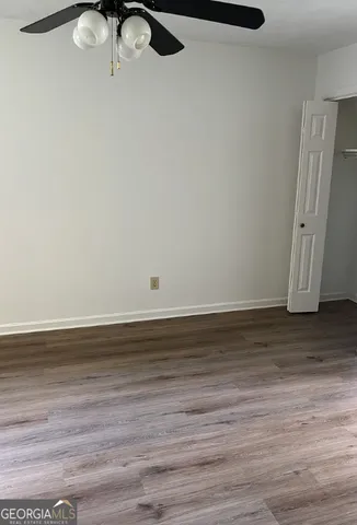 a view of a room with wooden floor