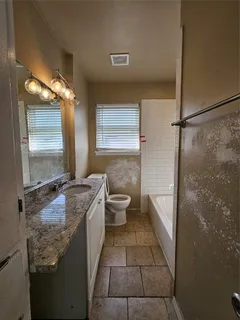 a bathroom with a granite countertop sink a mirror and a shower