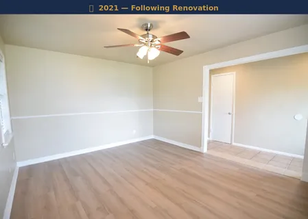 a view of a room with wooden floor and a ceiling fan