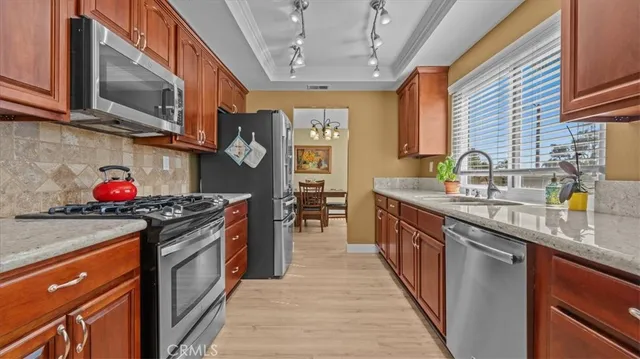 a kitchen with stainless steel appliances granite countertop a stove and a sink