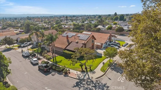an aerial view of a swimming pool with outdoor seating and city view