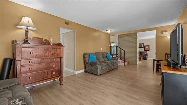 a living room with furniture and a mirror
