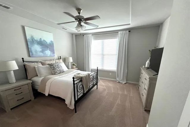 a spacious bedroom with a bed and a window