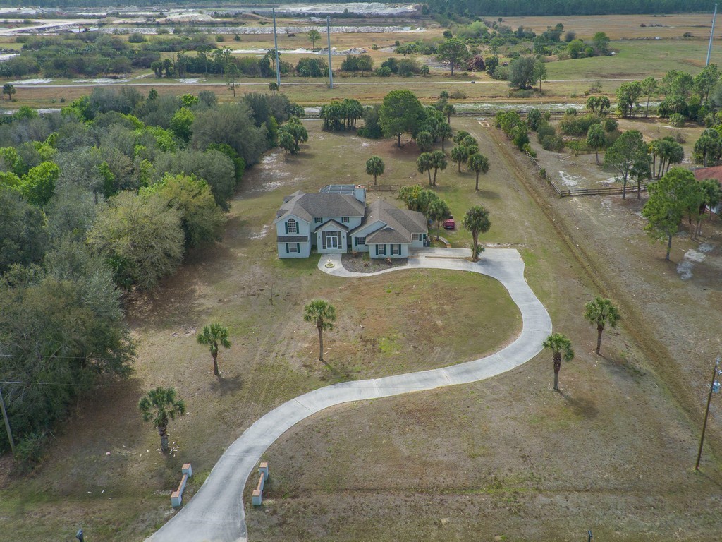 167 Deer Run Road Palm Bay, FL 32909 - Photo 34 of 35 an aerial view of a house with a yard and lake view