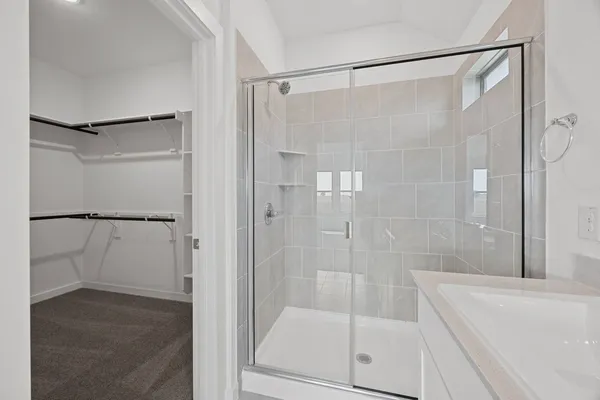 a bathroom with a glass shower door