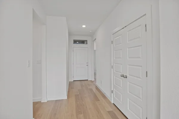 a view of a hallway with wooden floor