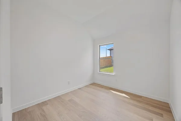 a view of an empty room and a window