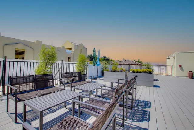 a view of a roof deck with furniture