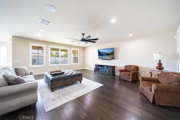 a living room with furniture a rug and a flat screen tv