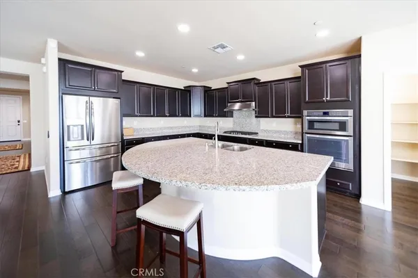 a kitchen with center island and a wooden floor