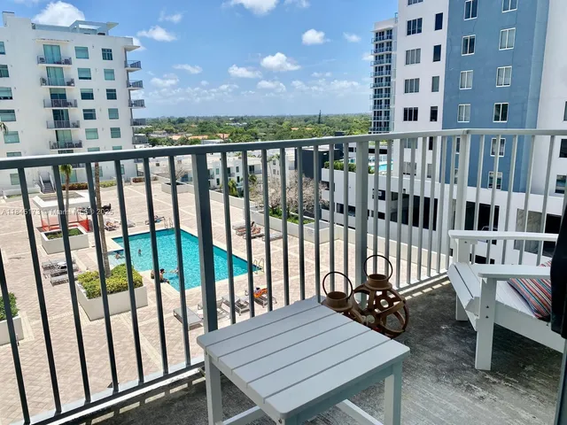 a view of a balcony with wooden chairs